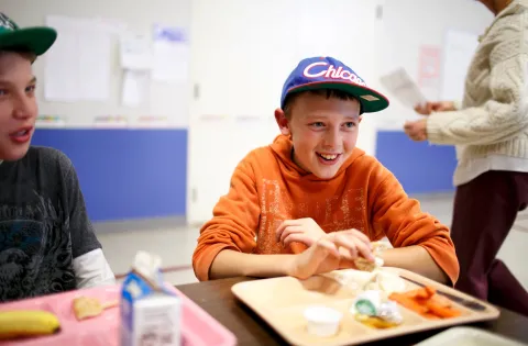 Boy eats school lunch.