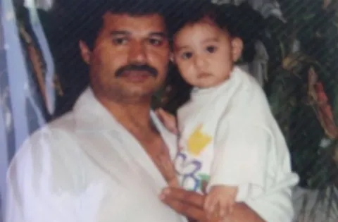 Old photo of man with moustache holding baby