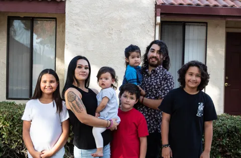 Family of 7 in front of house