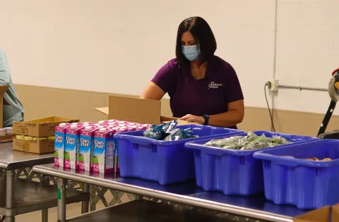 Volunteer preparing meals at food site