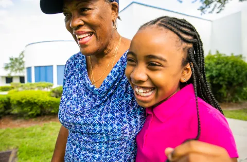 Girl and grandma smiling