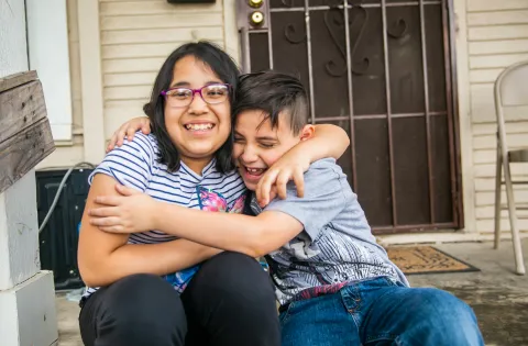 brother and sister hugging