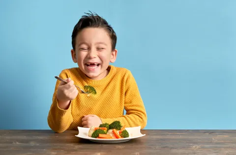 Boy enjoying vegetables