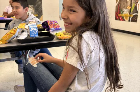 Girl Smiling in Cafeteria