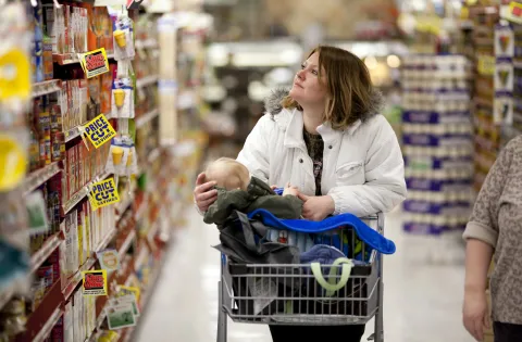 Mother grocery shopping with her young child