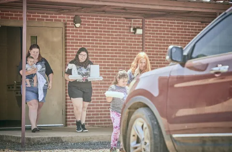 Family picking up meal in school