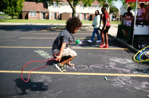 Kid jumping rope at a summer meal site.