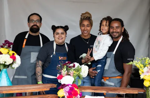 Group of 4 chefs holding daughter