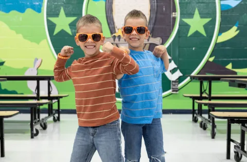 Twins with sunglasses in a school