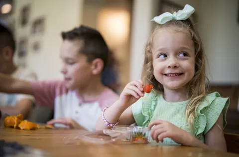White little girl eating strawberries