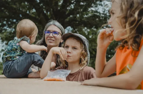 3 white Kids with mom at summer site