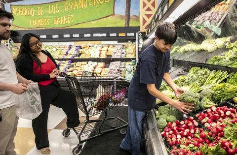 Family at supermarket shopping