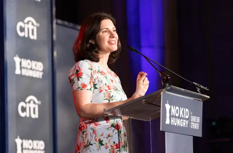 Anne Filipic speaking at podium
