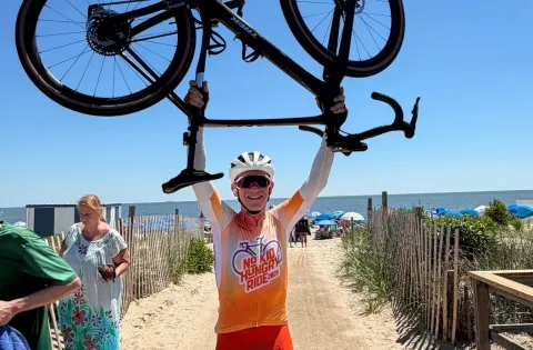 Man holding bike in the air