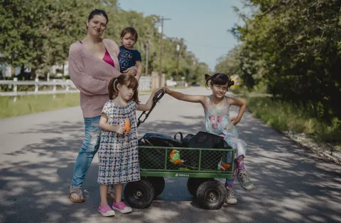 Family with little girls and cart